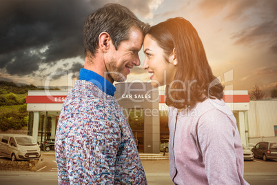 Composite image of close-up of couple standing face to face