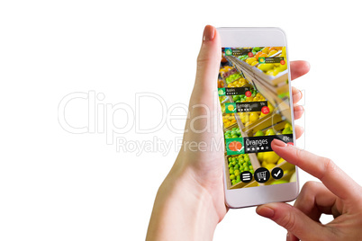 Composite image of hand holding smartphone