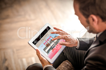 Composite image of businessman using tablet