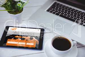 Composite image of tablet on desk