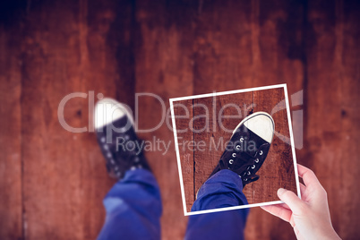 Composite image of hands holding black paper