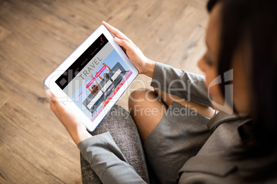 Composite image of businesswoman using tablet