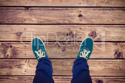 Composite image of man with canvas shoes on hardwood floor