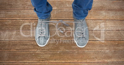 Composite image of low section of man with shoelaces tied togeth