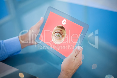 Composite image of businessman using his tablet