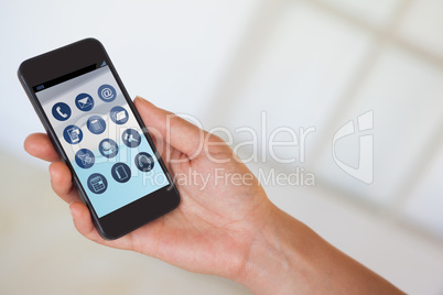 Composite image of womans hand holding black smartphone