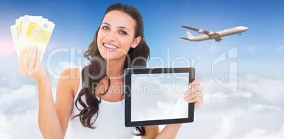 Composite image of pretty brunette using tablet pc