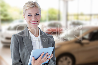 Composite image of smiling buisnesswoman using digital tablet