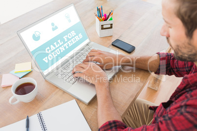 Composite image of creative businessman typing on laptop