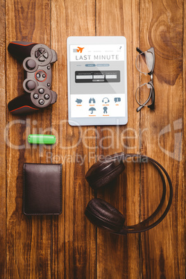 Composite image of tablet and glasses next to joystick music hea