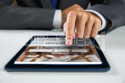 Composite image of businessman using digital tablet