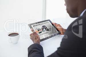 Composite image of businessman using digital tablet