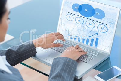 Composite image of businesswoman using laptop