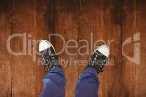 Composite image of man standing on hardwood floor
