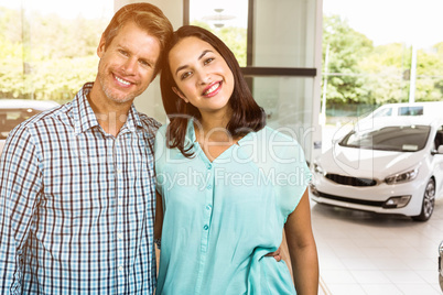 Composite image of portrait of happy couple standing