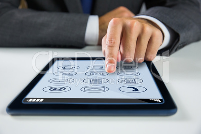 Composite image of businessman using digital tablet