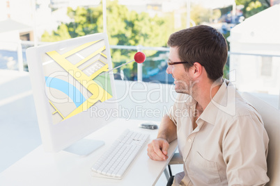 Composite image of casual businessman using computer