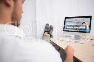 Composite image of businessman with legs crossed at ankle on off