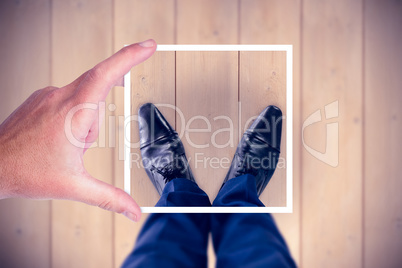Composite image of hand holding polaroid picture