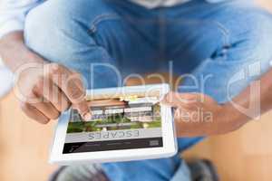 Composite image of businessman using digital tablet in creative