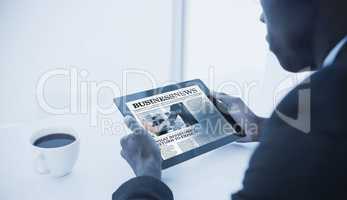 Composite image of businessman using digital tablet