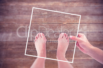 Composite image of hands holding black paper