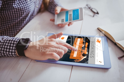 Composite image of hand using tablet and smartphone