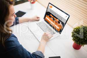 Composite image of woman using laptop