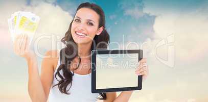 Composite image of pretty brunette using tablet pc