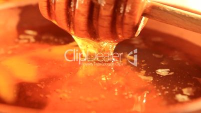 fresh honey with wooden dipper