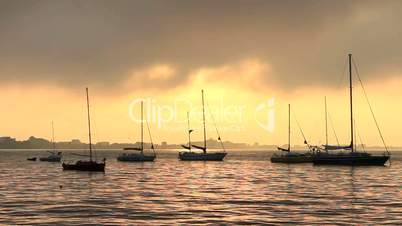 sailboats in the bay at sunrise