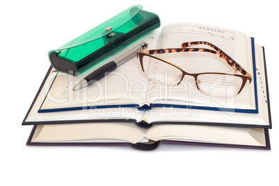 Glasses, books and notebooks on white background.