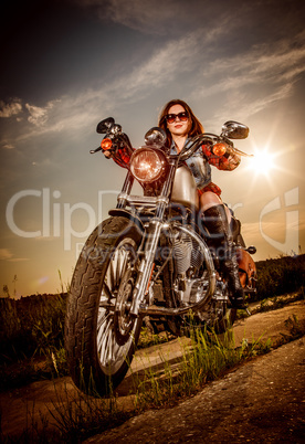 Biker girl sitting on motorcycle