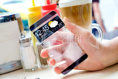 Smartphone with transparent screen in human hands.