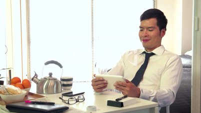 Japanese Businessman Business Man Using Ipad Digital Tablet During Breakfast