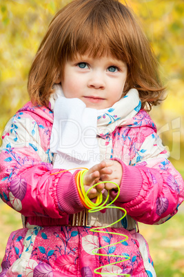 Girl playing in the park with a Rainbow spiral spring