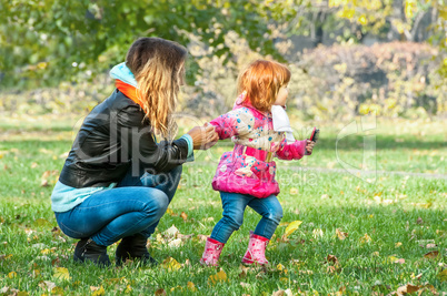 Mom plays with her daughter in the park