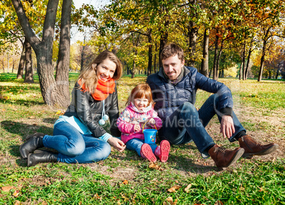 Happy young family in an autumn park