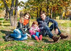 Happy young family in an autumn park