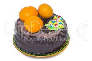 Chocolate cake and oranges on a ceramic dish on white background