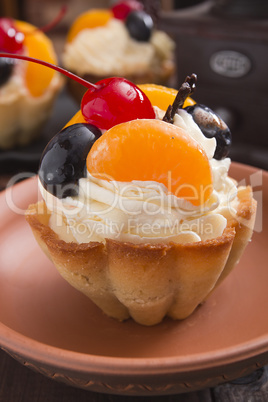 Basket of dough with cream and cherry