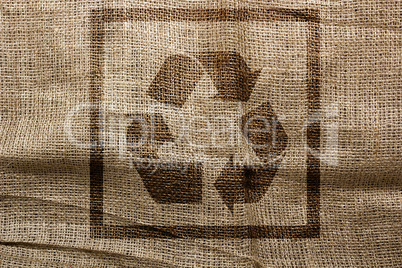 Stamp on sackcloth industrial recycling symbol