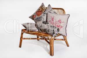 Decorative Pillows On A Wicker Bench