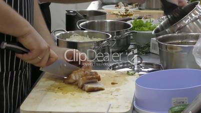 The Cook prepares meat