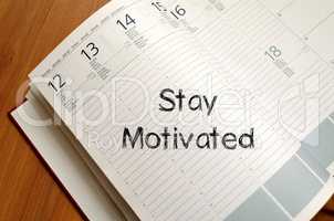 Stay motivated write on notebook