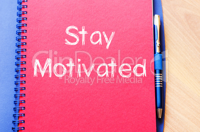 Stay motivated write on notebook