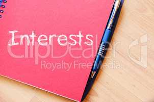 Interests write on notebook