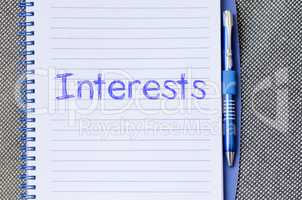 Interests write on notebook