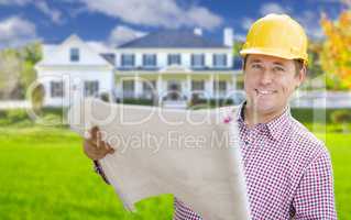 Contractor Holding Blueprints In Front of  Beautiful Custom Home