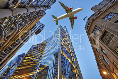 A jet plane flying over the city